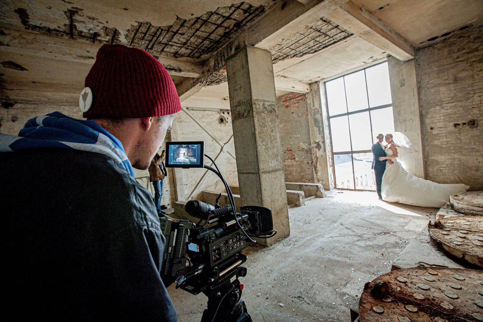 A candid moment during a wedding photoshoot in an abandoned building.